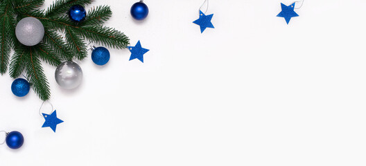 Christmas flatlay with fir branches, blue and silver  decorations on white background. Christmas composition, top view, copy space. New Year background.
