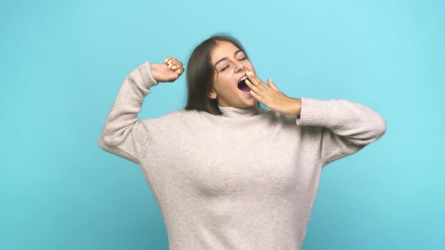 Young caucasian woman yawning showing a tired gesture covering mouth with hand