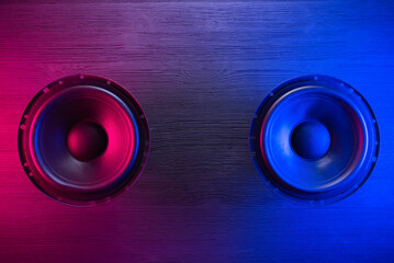A car audio loudspeaker on the table in the neon lights.
