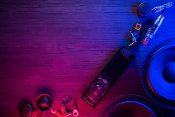 A car audio equipment on the table in the neon lights background.