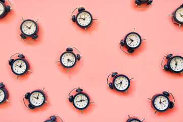 alarm clocks on pink