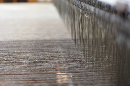 Close up of many meshes and threads of an artisanal loom