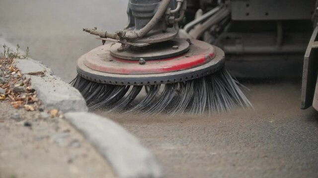 Machine clears the asphalt with a big sweeper