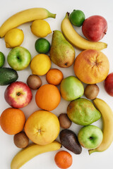 Top view of various colorful fresh summer fruits isolated over white background
