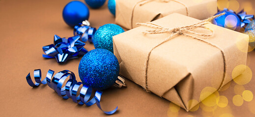 Christmas gifts with Christmas decorations on a brown background. Christmas background. Side view. Copy space.
