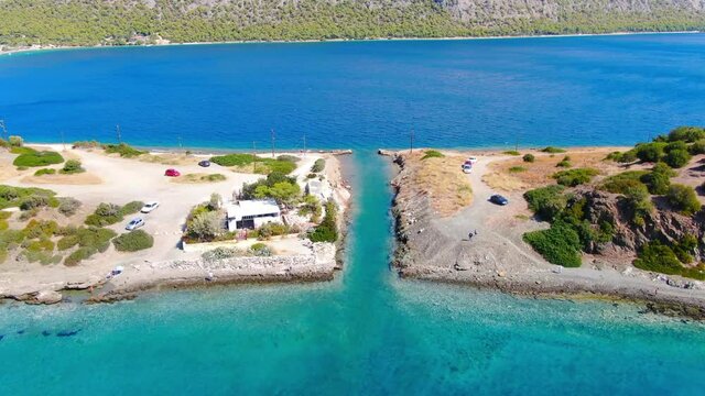 Aerial view of turquoise clear water and sandy beach of Ireon or Limni Vouliagmeni Lake in Peloponnese, Greece 