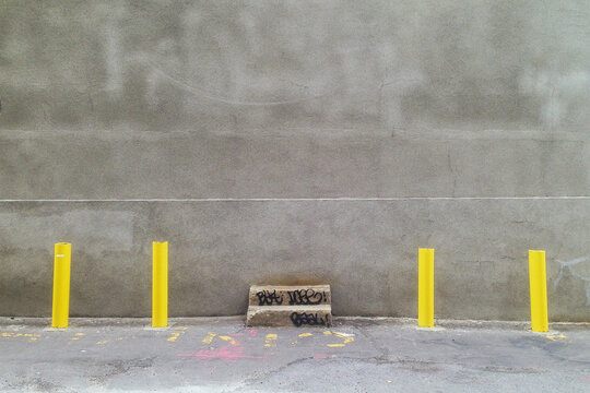 Gray wall with 4 yellow pole