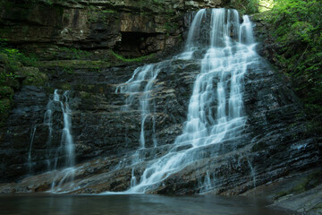 Beautiful reward for a spring hike to Margarette Falls on the West Fork Dry Creek in Greene County, Tennessee displaying a 60 foot, fan shaped waterfall with a lush green canopy.