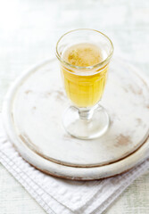 Glass of beer on bright wooden background.	
