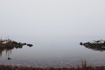 A fog covered riverbank in Maryland during the winter month of December