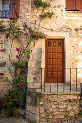 Fototapeta na wymiar a door in a stone building in Viviers. Viviers is a commune in the department of Ardèche in southern France. It is a small walled city situated on the bank of the Rhône River.
