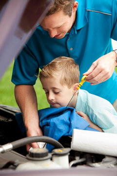 Father: Father and Son Checking the Oil Level