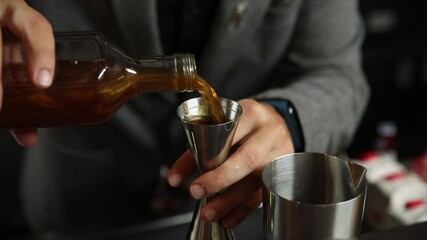 The bartender prepares an alcoholic cocktail with ice. Macro photography