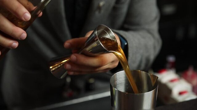 The bartender prepares an alcoholic cocktail with ice. Macro photography