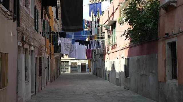 Laundry hanging between two old buildings in venice italy
