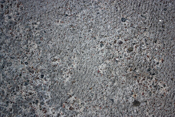 Grey cement pavement with little different stones