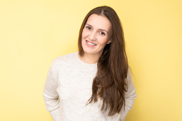 Obraz premium Happy attractive tatar young woman smiling and laughing isolated on yellow background with copy space, face portrait