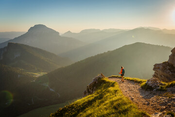 Hiker walking in the mountain at sunset