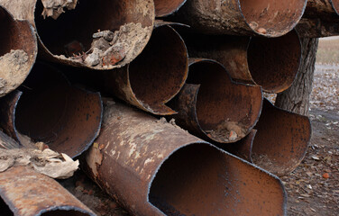 Fragments of old cast-iron water pipes. After many years of operation corroded metal pipe was...