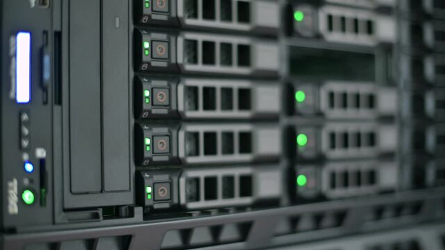 Blinking bulbs on hard drives in a server cabinet, close-up, bokeh. information recording process