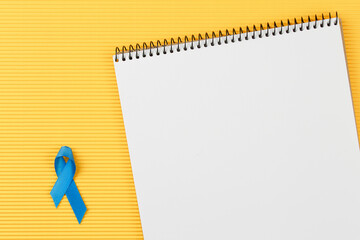 blue prostate ribbon on open notebook 