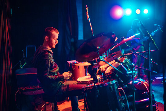 Young man playing drums on stage