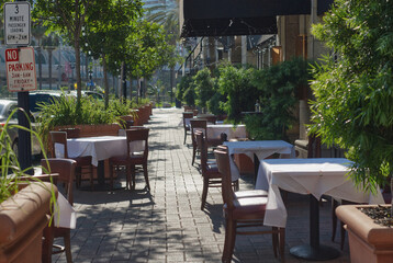Fototapeta na wymiar Outdoor dining set up with a sidewalk running through it.