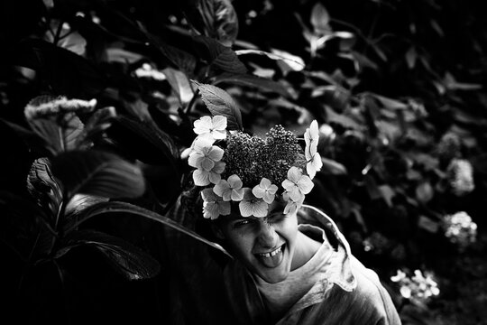 Cheeky young man with flowers covering his face