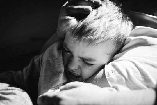 Close up of father comforting his crying child.