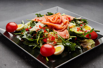 Fresh seafood salad served with salmon and red caviar