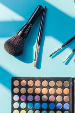 Make up essentials on blue background