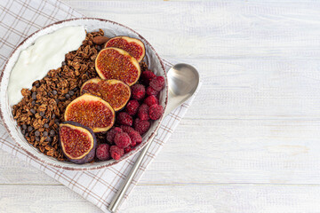 Homemade granola with chocolate and nuts on a light background. Vegetarian dish. Healthy breakfast.