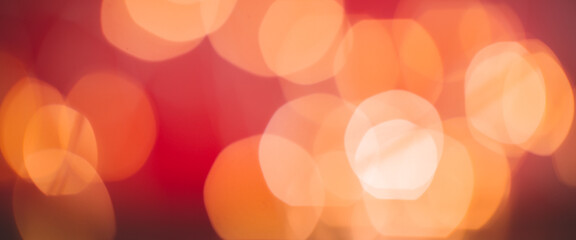 Defocused abstract bokeh lights background. orange, red, black colors. christmas and new year concept. banner