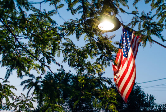 American flag lit by a street lamp at night