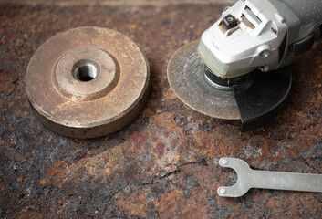 Angle grinder on metal on iron background.