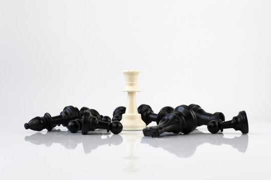 White and black chess pieces on a white background. Leadership and success concept.
