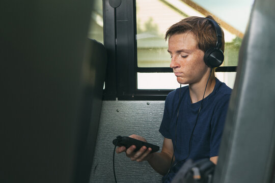 School Bus: Boy Listens To Music During Bus Ride