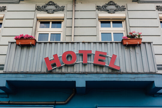 Hotel sing on balcony of old blue building