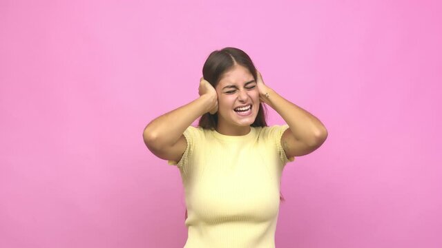 Young caucasian woman covering ears with hands trying not to hear too loud sound
