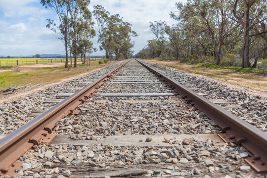 Straight train track in remote landscape