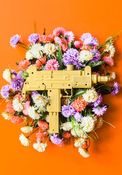 Uzi machine gun on colorful flower bouquet.