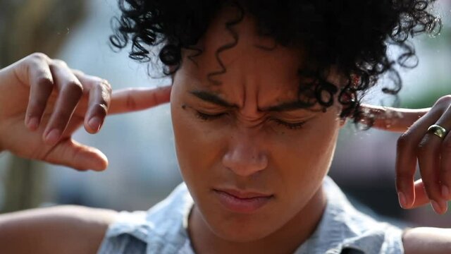 Person not wanting to listen putting finger inside ears