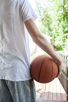 boy holding onto basketball