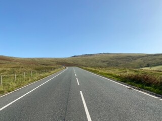 High on the moor tops, on Halifax Road, with a lone cyclist in the distance near, Sowerby Bridge, Yorkshire, UK
