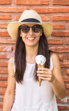Smiling woman eating ice-cream