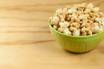 A Bowl Of Tasty Caramelized Popcorn; On Wooden Background.