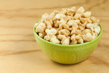 A Bowl Of Tasty Caramelized Popcorn; On Wooden Background.