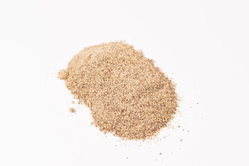 Powdered black ground pepper pile from top on white background