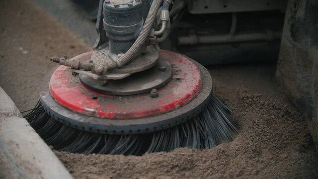 Industrial machine levels concrete dust with a sweeper