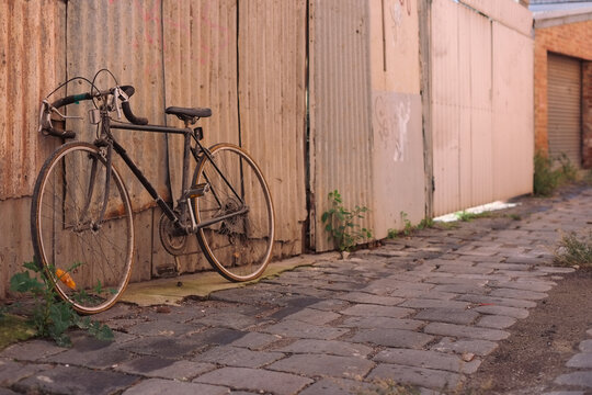 Old bike parked in laneway
